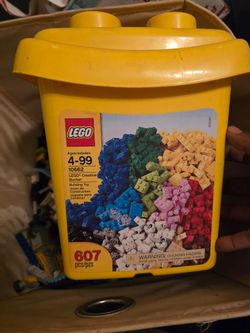 random Lego pieces and Lego storage container