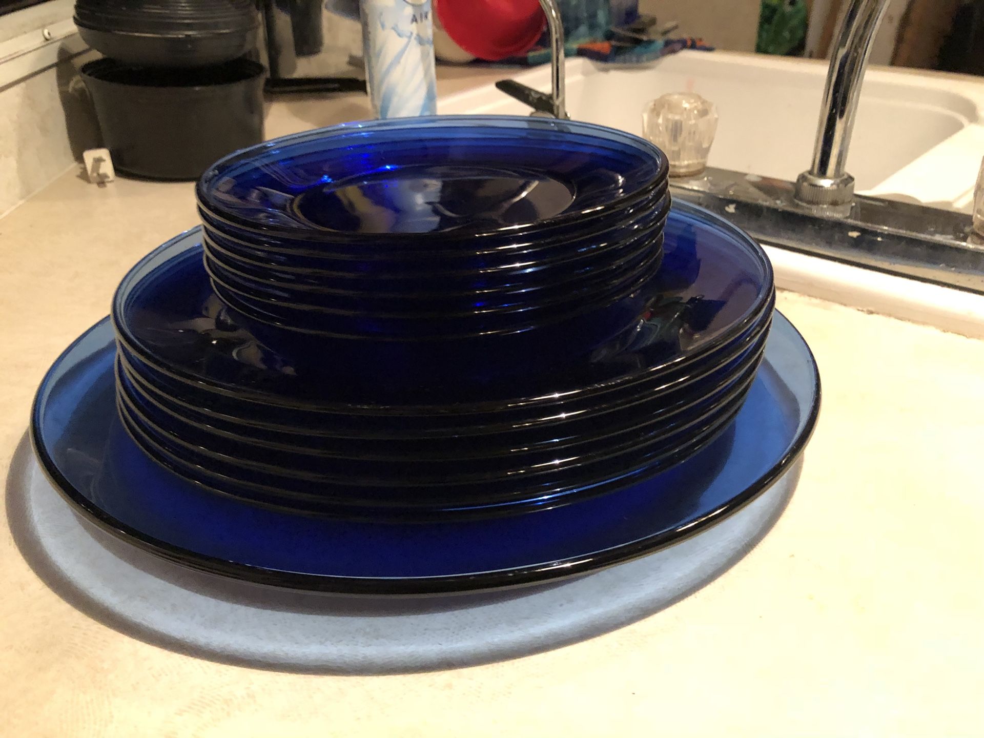 Cobalt blue glass dinnerware 13 piece set. Includes 6 dinner plates, 6 smaller dessert plates, and a platter.