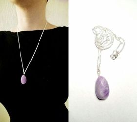Necklace with free form white and purple amethyst pendant and on a silver colored chain