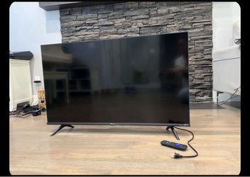 Westinghouse 4K Ultra HD Smart Roku TV, featuring a slim black bezel and angular side legs