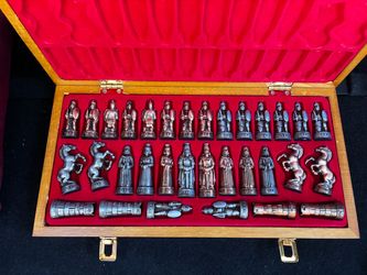 beautiful decorative chess set featuring detailed Roman/warrior-style chess pieces in gold and silver tones. The pieces come in a beautiful wooden sto