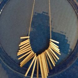 Stylish silver tone necklace with unique design.