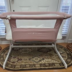 READ. Nice Baby Delight Beside Bassinet 