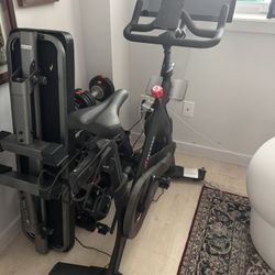 Peleton bike with weights and mat