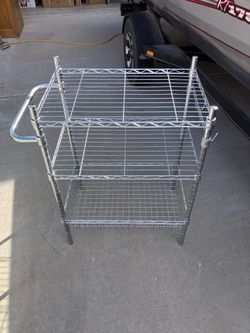 Like new 3 shelf unit. Handle on one end and three towel hooks on the other end