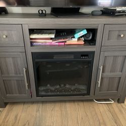 Entertainment center with space heater/ faux fire place. Console table