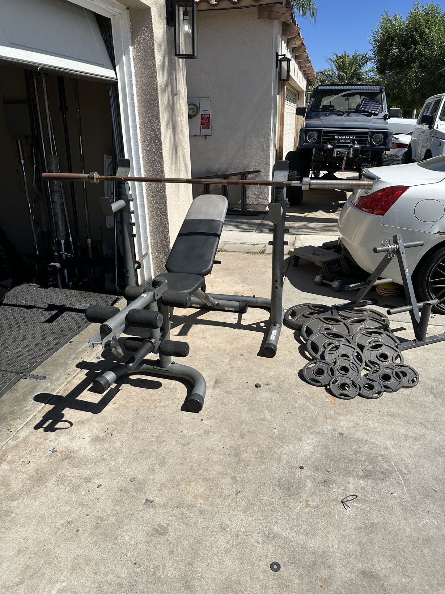 Bench press/squat rack with 7ft 45lbs bar plus 255lbs of Olympic weights and weights tree