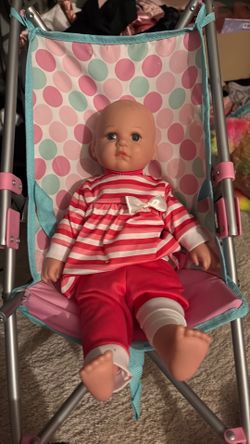 Baby doll with food, diaper bag, and stroller