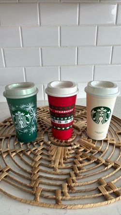 Three plastic Starbucks cups with lids