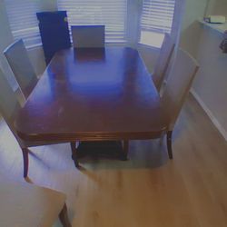 Large wooden table 6 chairs with covers