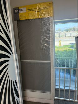 Hinged screen door with pet grille