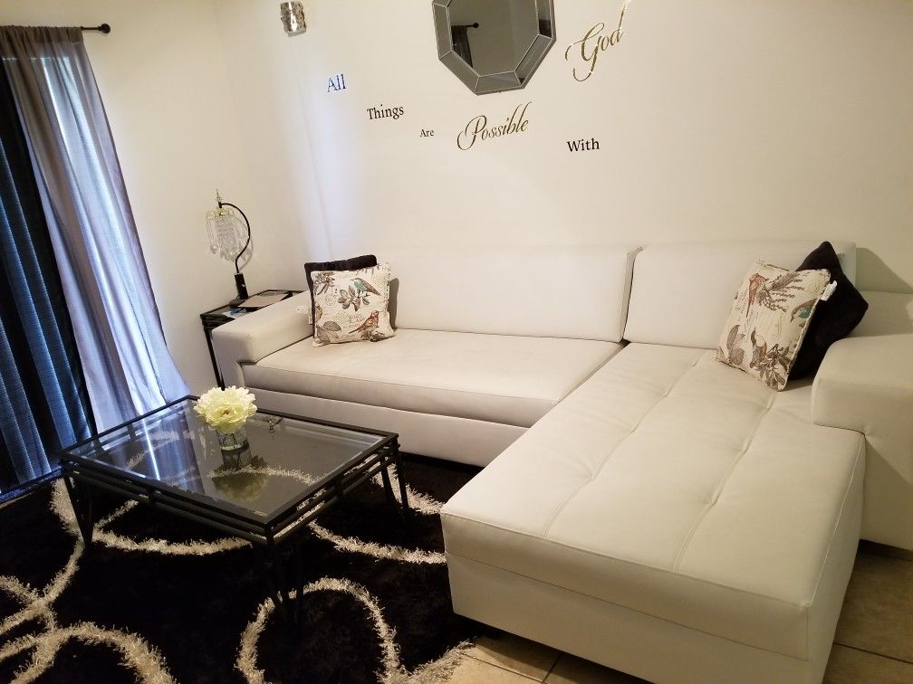 White couch...italian leather. With everything you see..rug coffee table 2 lamps everything included