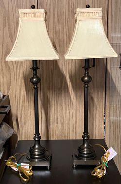 a pair of 30 inch Madison bronze table lamps featuring slender candlestick metal bases and flared, inverted-corner square beige fabric shades EC