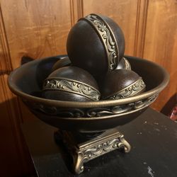 Decorative centerpiece in dark brown/black and gold. 12 x 7.5 inches tall.