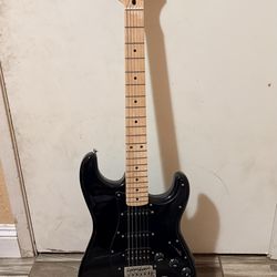 electric guitar + amplifier