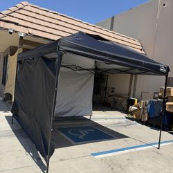 KAMPKEEPER Pop Up Canopy Tent designed with a black weather-resistant canopy fabric, an integrated overhead air vent, and a silver-coated interior lin