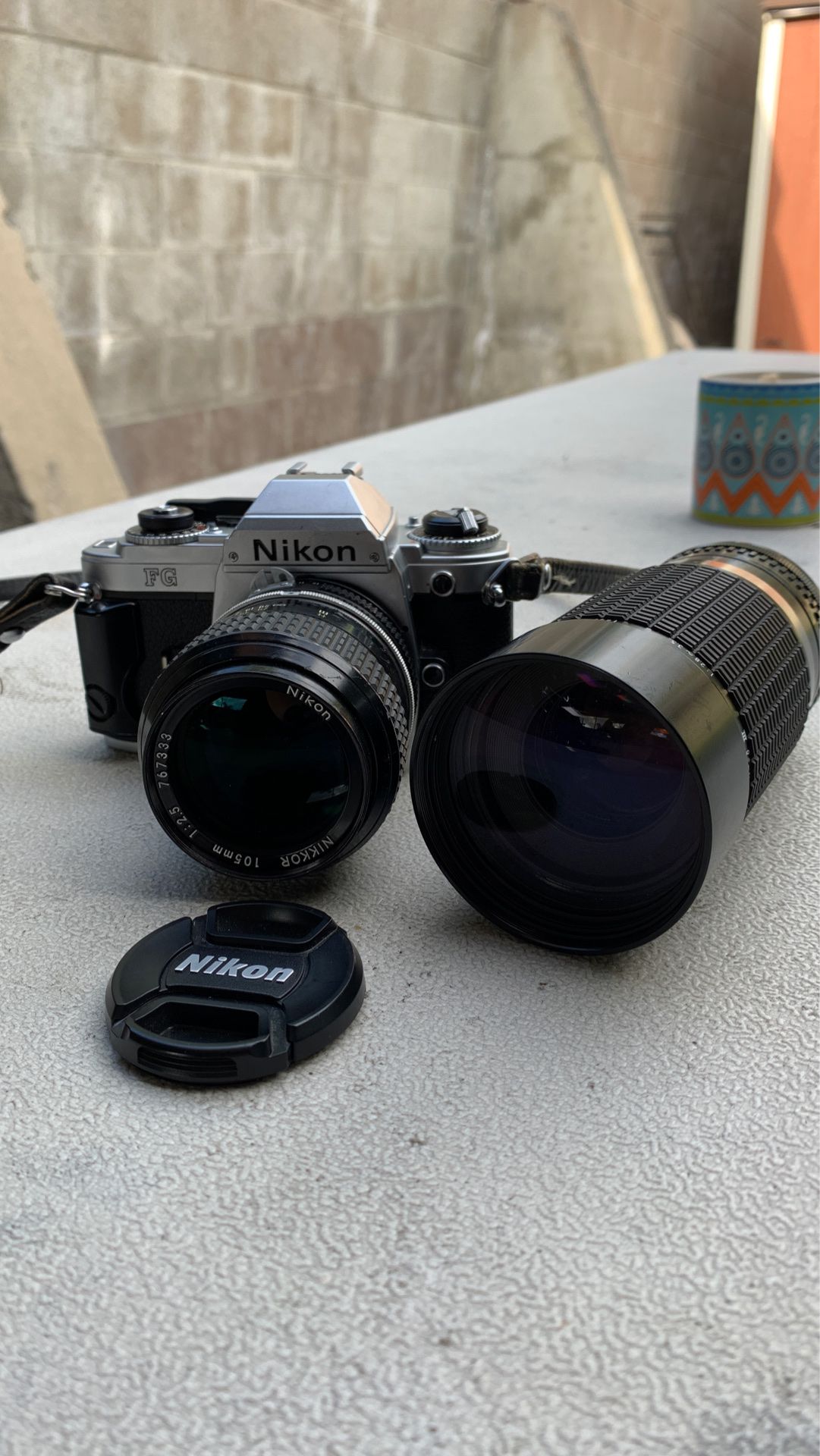 Nikon FG 35mm SLR camera with 2 lenses and camera bag