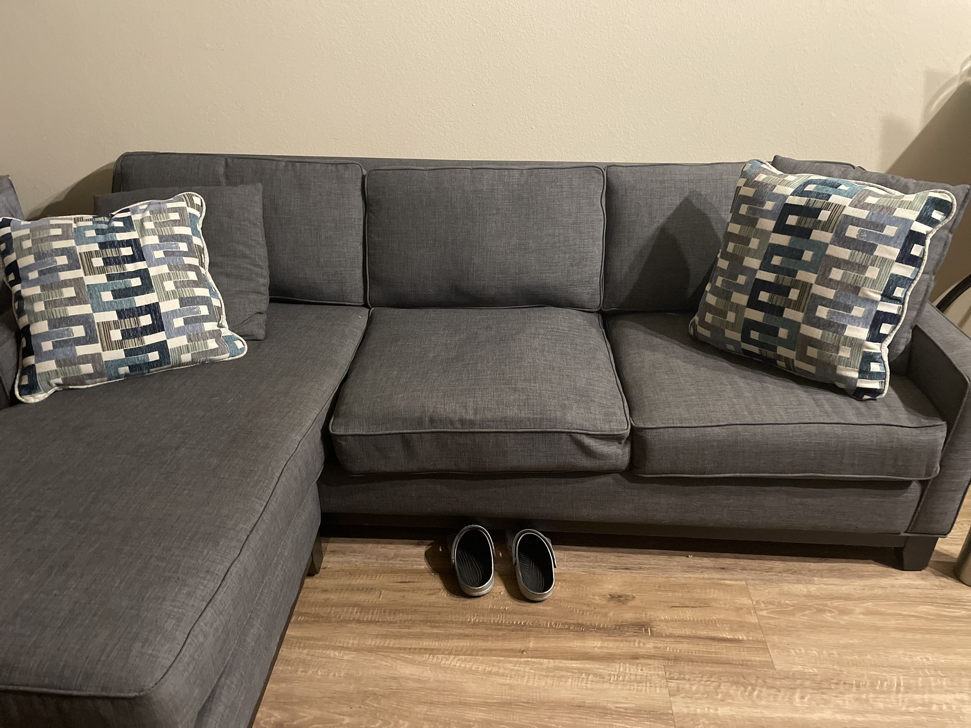 Grey L Shaped Couch With Decorative Pillows