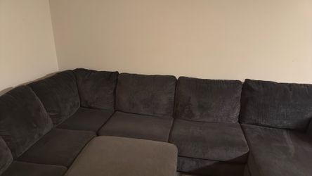 Dark grey couch with ottoman table