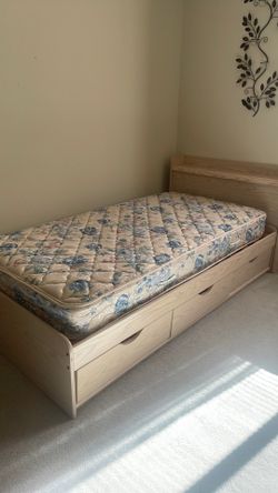 Twin bed with headboard and mattress