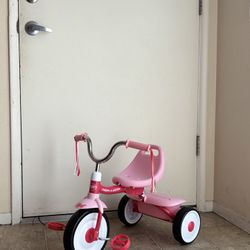Pink and red tricycle