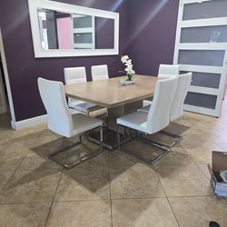 Extending wood dining table and 6 leather white chairs