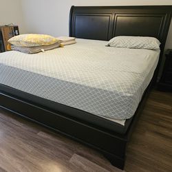 King bed frame with box spring and mattress.