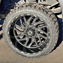TIS 544BM 24x12 Rims 33" R/T Tires Ford F150 Silverado Sierra Ram 1500 Finance Available