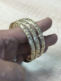 These solid gold layered bangles are diamond-cut designs, A-1 quality, durable, yellow gold finish. The gold plating is top class 14Kt durable micron