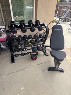 Dumbbells rubber coated 5-40lbs with rack and kettlebells plus adjustable bench 380lbs total
