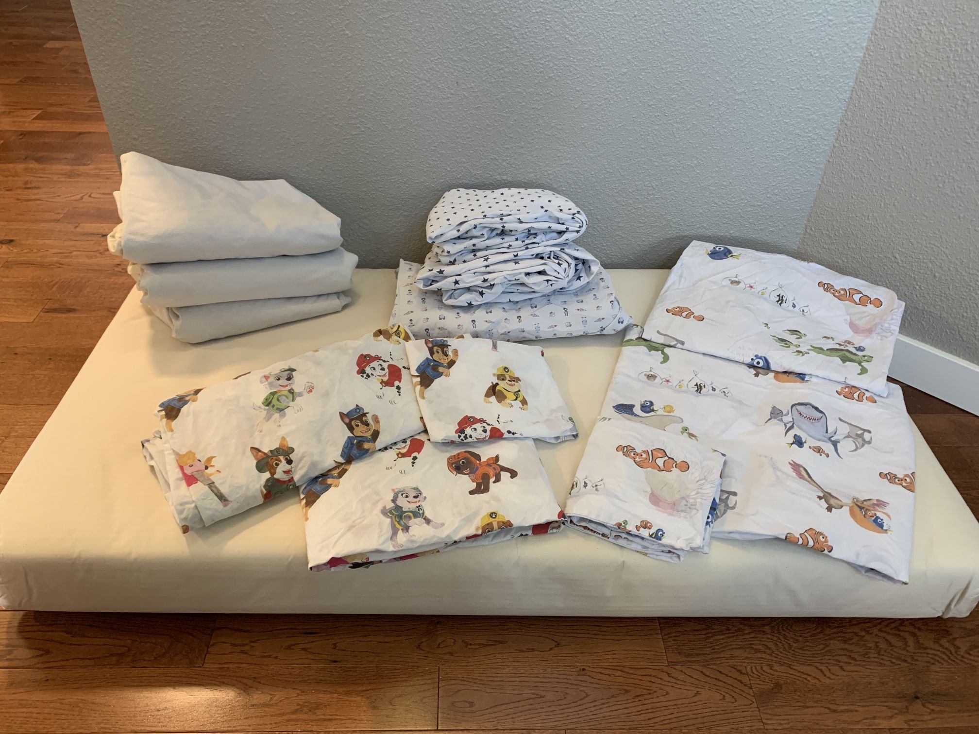 Naturepedic 2-stage Crib & Toddler Mattress, Naturepedic Mattress Covers, & Pottery Barn Sheet Sets (Paw Patrol & Finding Nemo)