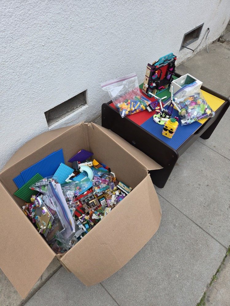 KidKraft Double-Sided Play Board Storage Table with a box of many Legos 