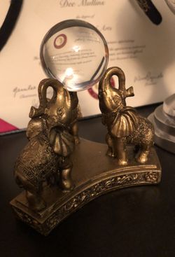 Elephant sculpture with glass ball