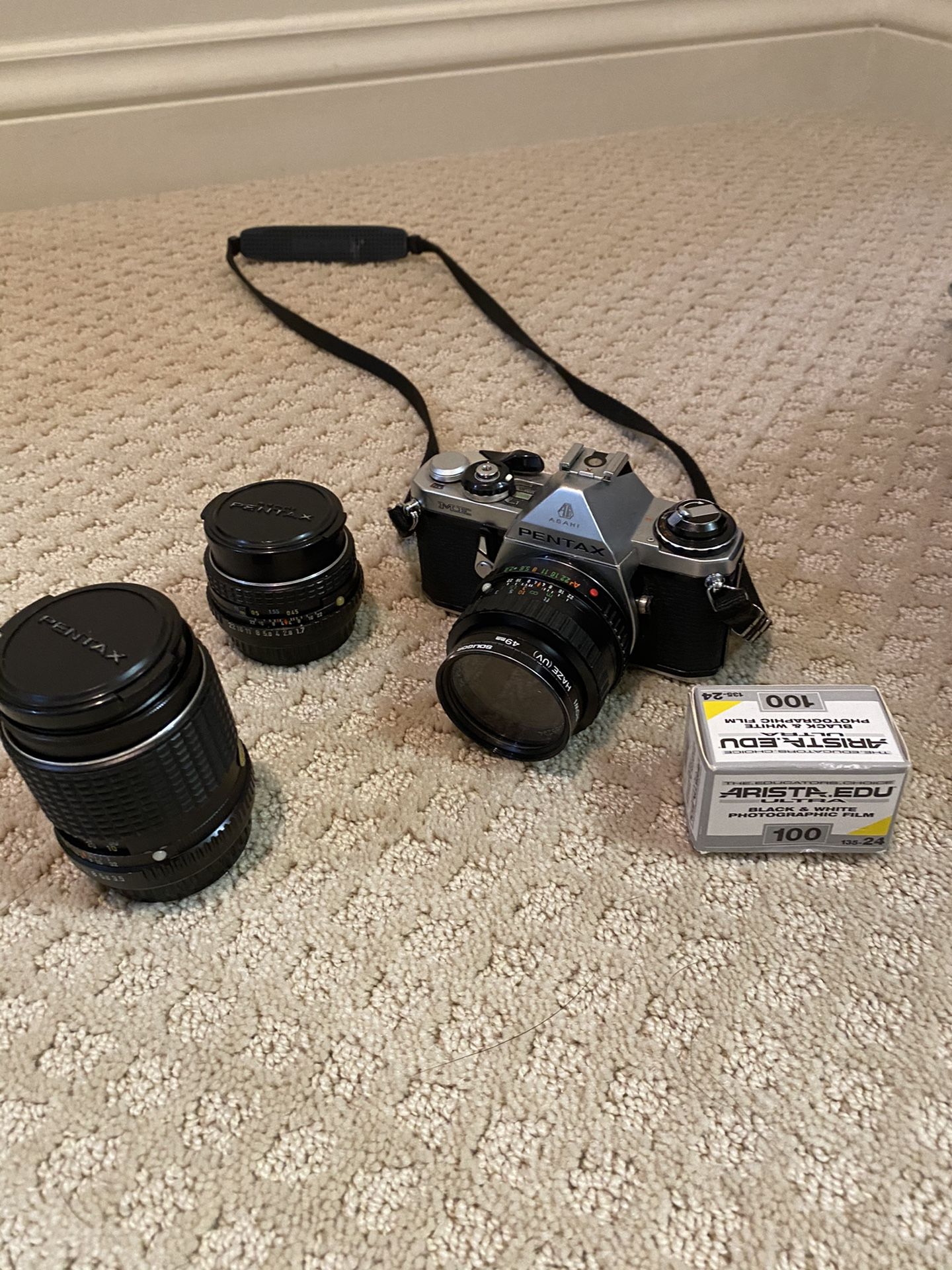 Pentax ME camera with two extra lenses and one roll of film