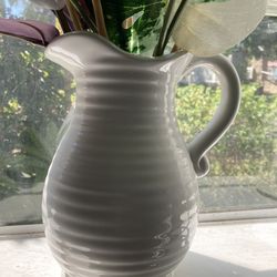 Elegant white ceramic pitcher with a ribbed design.