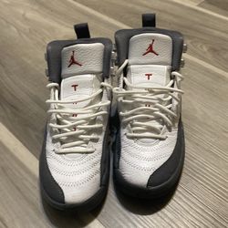 Jordan 12 Retro in the White/Dark Grey-Gym Red colorway.