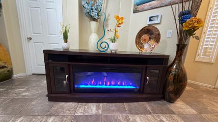 Beautiful fireplace /tv stand in excellent condition with Bluetooth speakers 70”