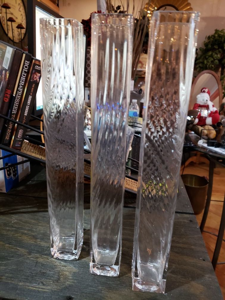 Three 16x2x2 glass vases.