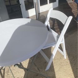 White folding chairs and table