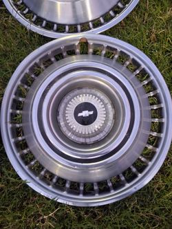 Set of 4  intage Chevy hub caps  with center pieces