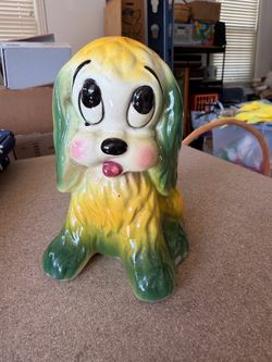 Vintage 5” ceramic dog planter featuring a whimsical cartoon-style pup with oversized eyes, rosy cheeks, floppy green ears, and a bright yellow and gr