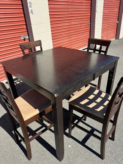 Square wooden high table and four chairs