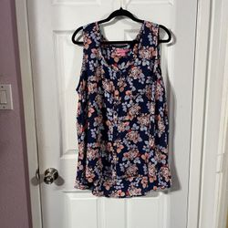 Women’s size 22 / 24 Sleeveless Top Tunic Length.  Made of 100% Polyester.  Background Navy Blue floral print.  The front is a  shorter than the back.