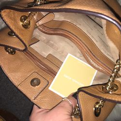 Tan leather Michael Kors purse with gold chain strap that you can use for a cross body or tote size