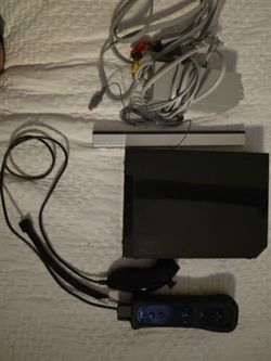 Black Nintendo wii with wii motion controller