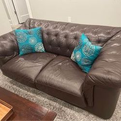 leather sofa and loveseat and coffee table