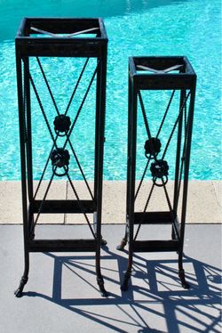 A pair of vintage metal plant stands with beautiful details