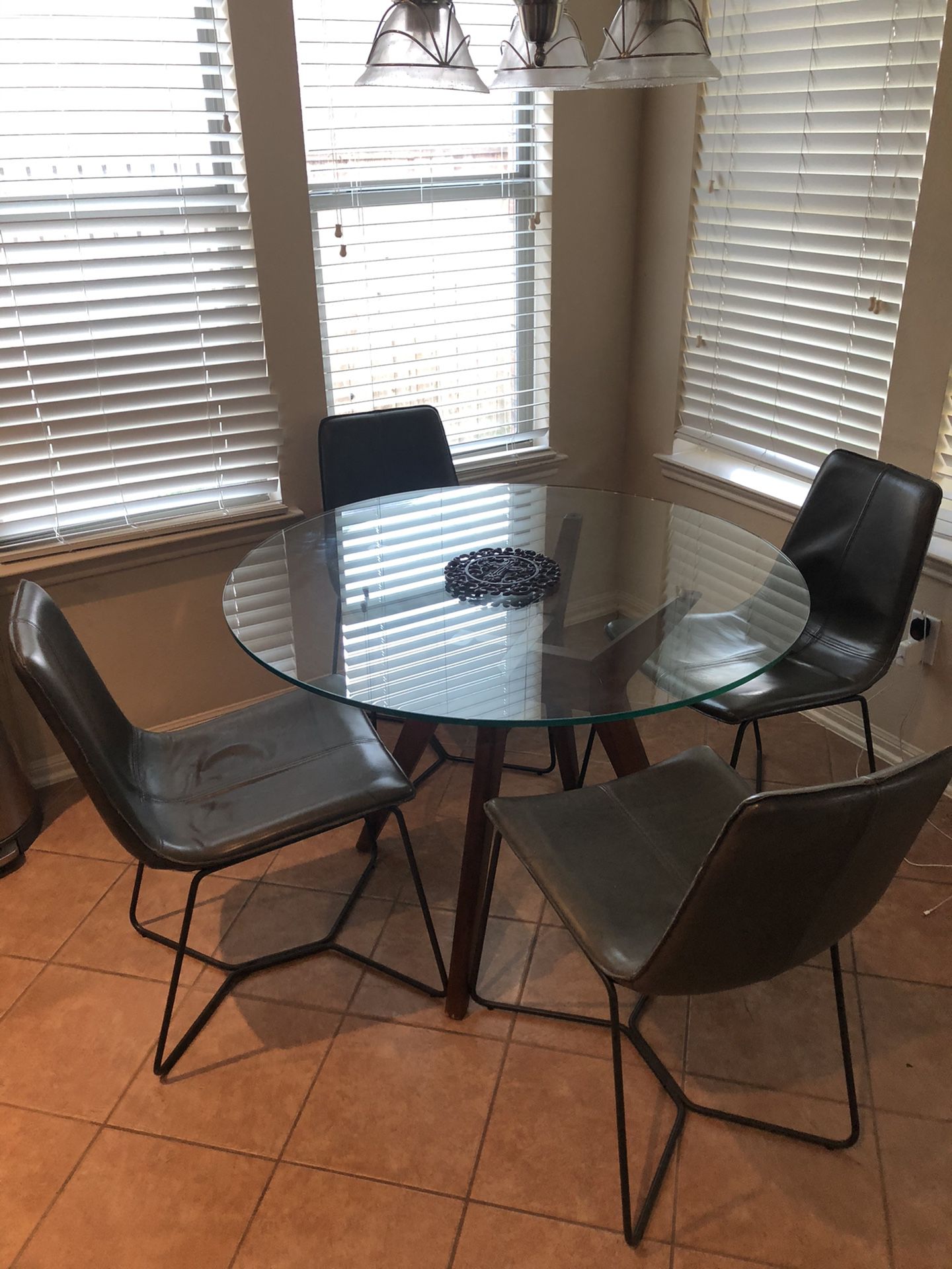 Glass dinette table and 4 chairs from West Elm. Selling due to move to new home with a different floor plan.