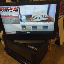 42 Inch  Older Model Olevia  With  Lots Of Feathers  Come With  Tv Stand And Remote, It's All Good.