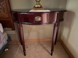 Bombay Company mahogany entryway table featuring a central drawer with brass hardware.